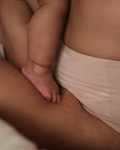 Close up of mother holding baby on lap